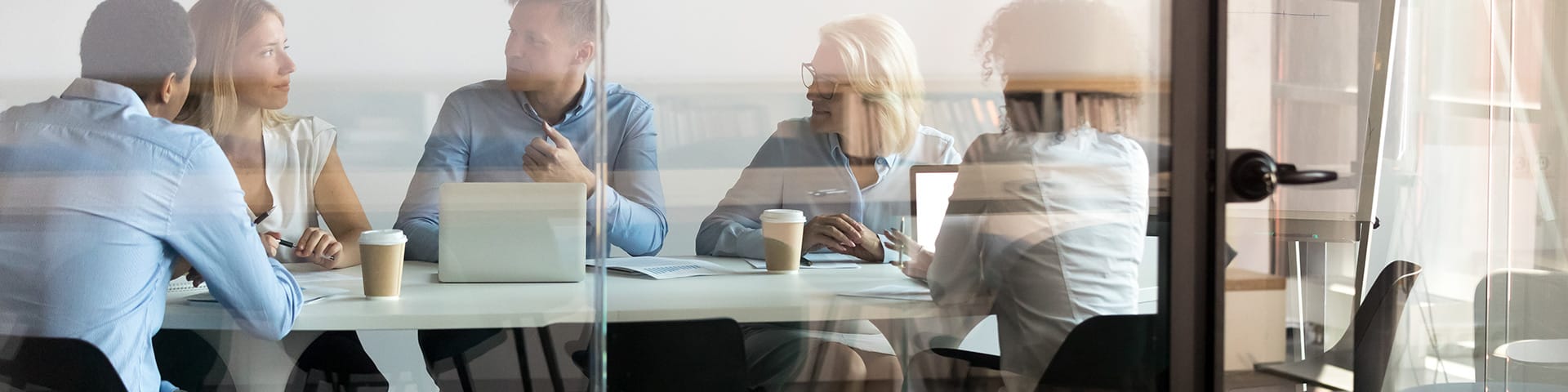 Business professionals meeting in a conference room discussing solutions – Contact DEME LLC for executive assistance and business support services.